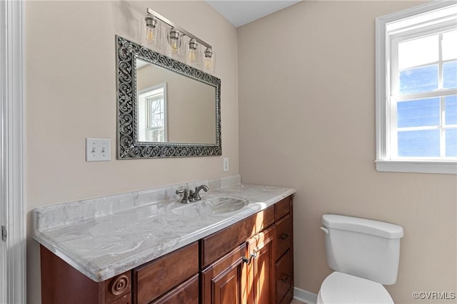 half bath featuring toilet and vanity