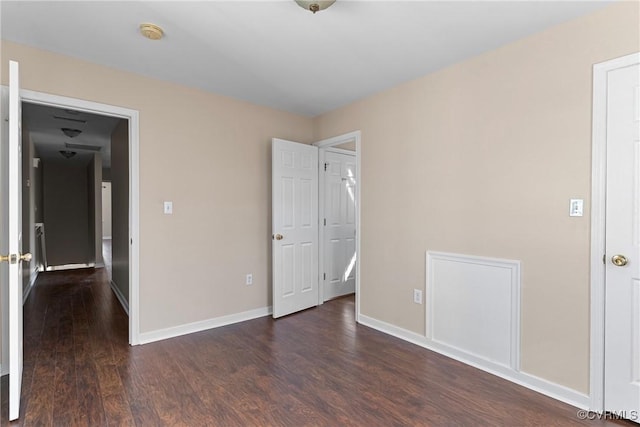 unfurnished bedroom featuring baseboards and wood finished floors