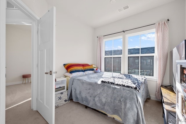 bedroom with visible vents and carpet flooring