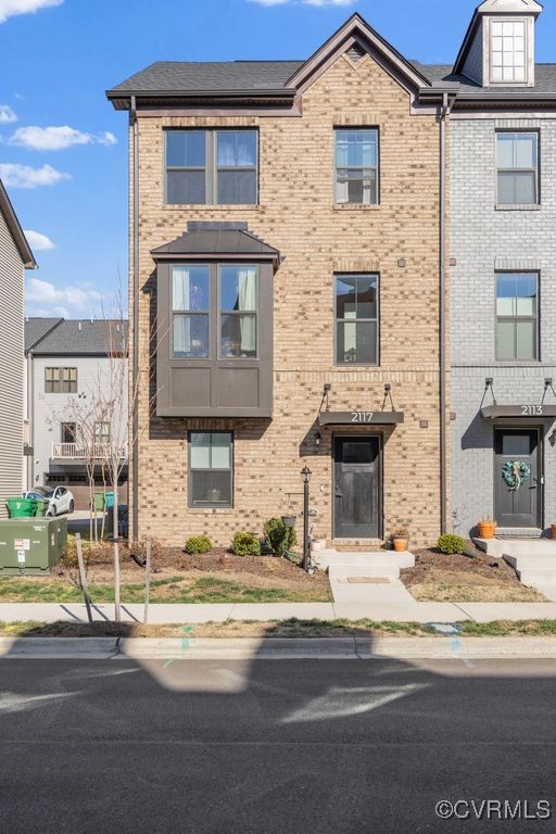 townhome / multi-family property with brick siding