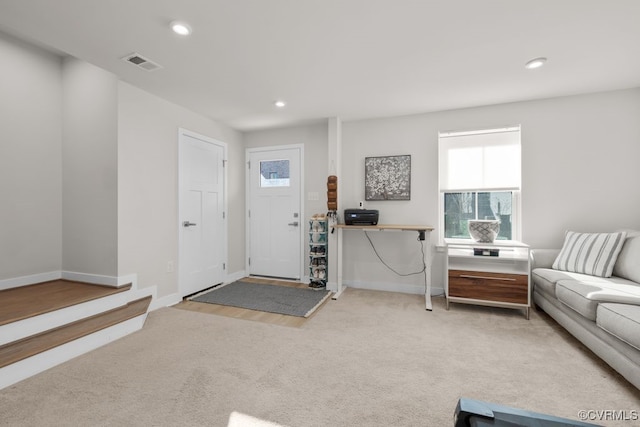 foyer with carpet floors, recessed lighting, visible vents, and baseboards