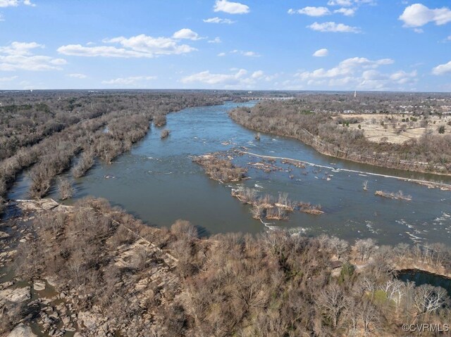 aerial view featuring a water view and a forest view