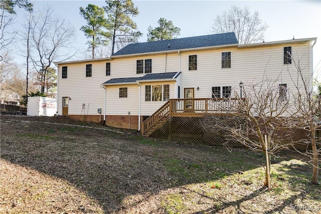 rear view of property with crawl space, stairway, and a deck