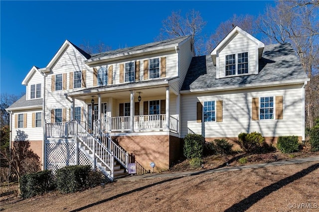 view of front of property featuring a porch and stairway