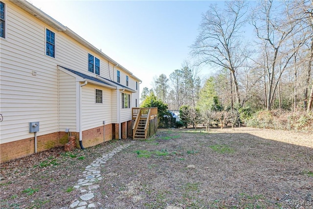 view of yard with stairs and a wooden deck