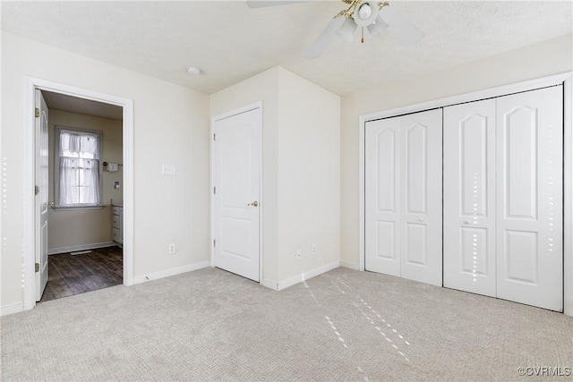 unfurnished bedroom featuring a closet, carpet flooring, ceiling fan, and baseboards