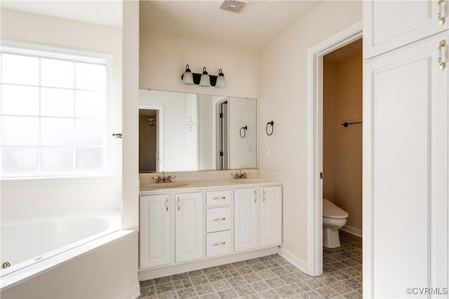 bathroom with double vanity, visible vents, toilet, a bath, and a sink