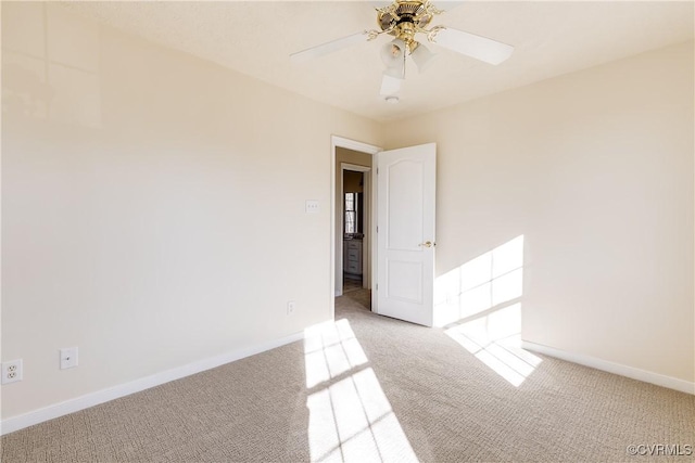 spare room featuring carpet flooring, a ceiling fan, and baseboards