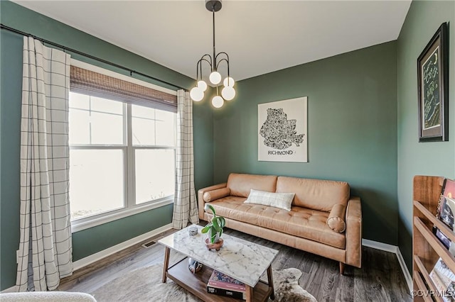 living area featuring baseboards and wood finished floors