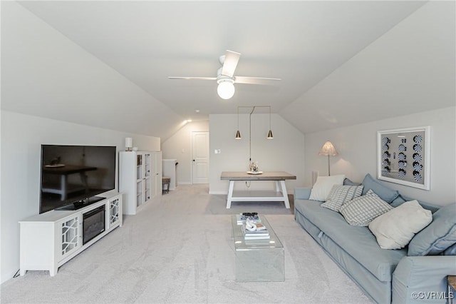 carpeted living area featuring ceiling fan and vaulted ceiling