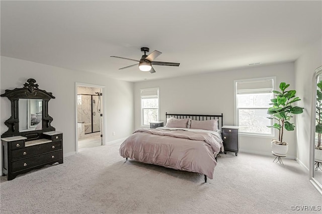 carpeted bedroom with baseboards, a ceiling fan, and ensuite bathroom