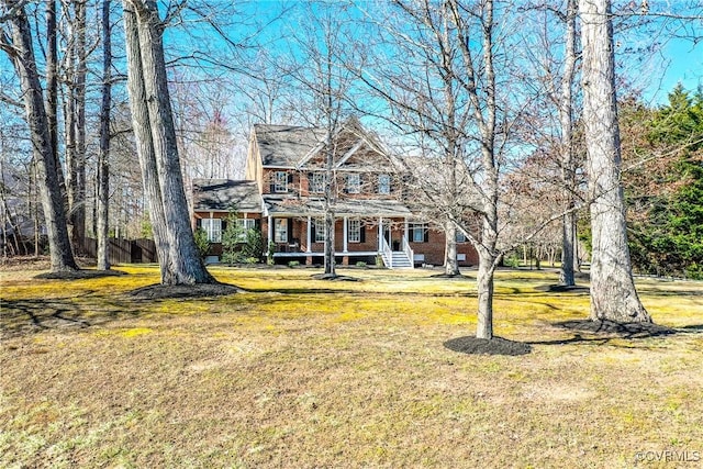 view of front of property featuring a front lawn and brick siding