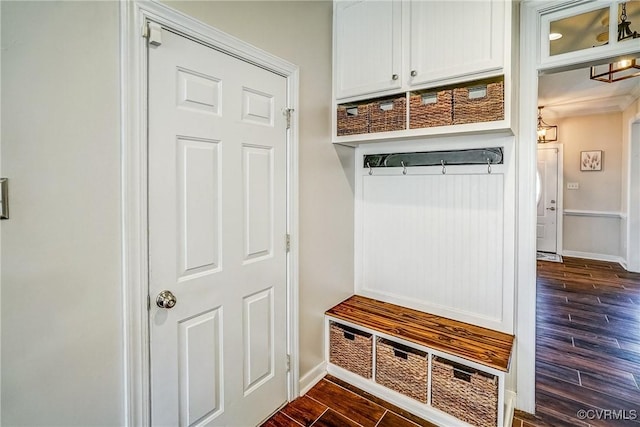 mudroom featuring baseboards and dark wood-style flooring