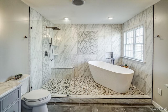 bathroom with vanity, a freestanding bath, tile patterned flooring, and a walk in shower