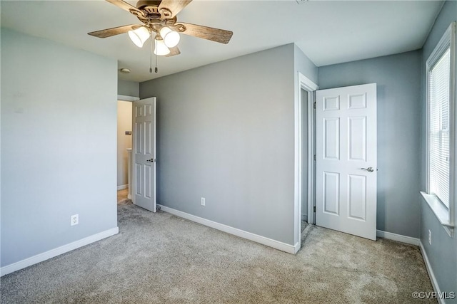 unfurnished bedroom with baseboards, carpet floors, and ceiling fan