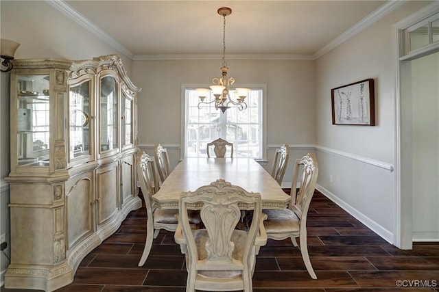 dining room with ornamental molding, baseboards, a chandelier, and wood finish floors