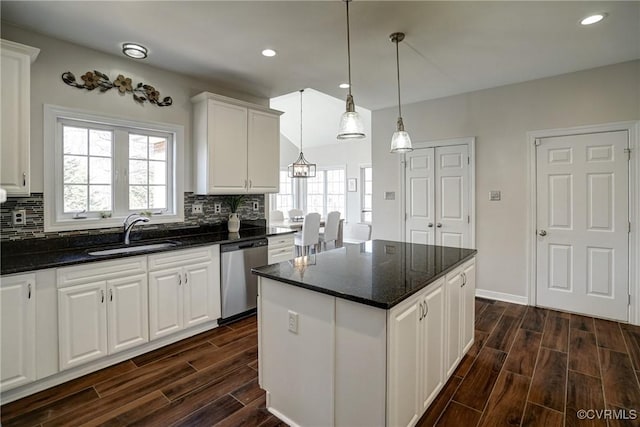 kitchen featuring a sink, backsplash, a center island, dishwasher, and wood tiled floor