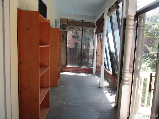 hall featuring a healthy amount of sunlight and wood finished floors