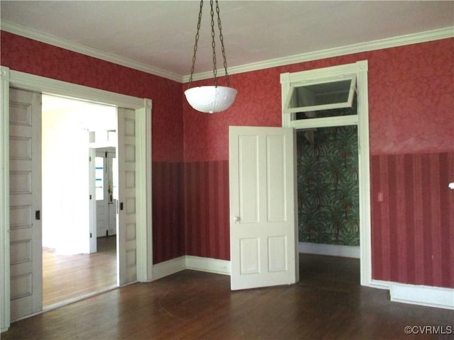 unfurnished dining area with crown molding, wood finished floors, and wallpapered walls