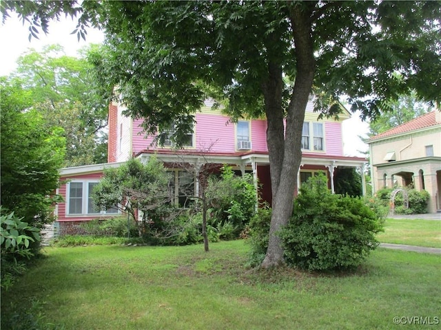 view of front facade featuring a chimney and a front yard