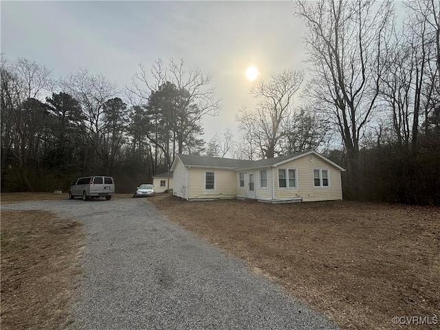 view of front facade with gravel driveway