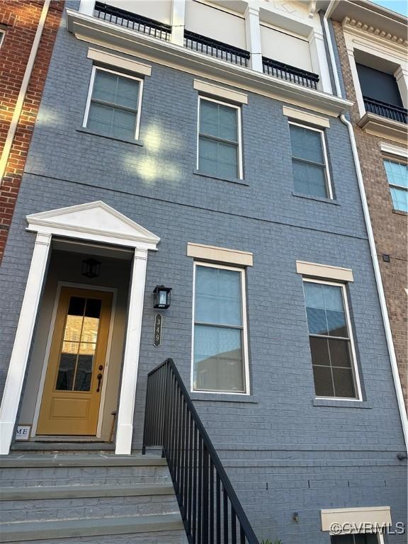 doorway to property featuring brick siding