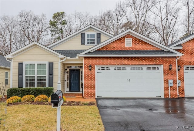 view of front of home with aphalt driveway, a front lawn, an attached garage, and brick siding