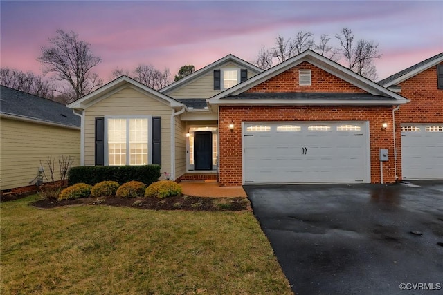 view of front facade with driveway, a front lawn, an attached garage, and brick siding