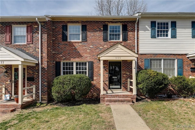 townhome / multi-family property with brick siding