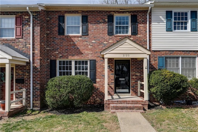 view of property featuring brick siding