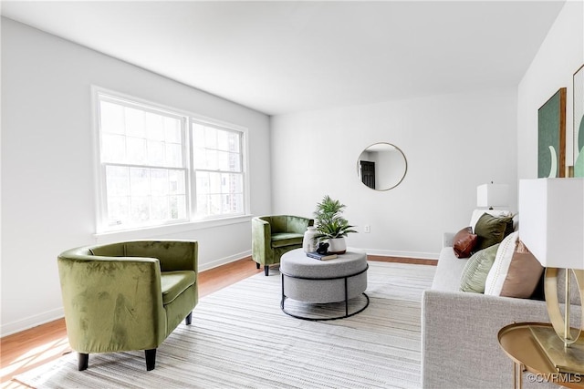 living area with wood finished floors and baseboards