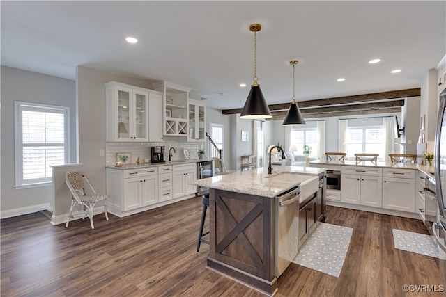 kitchen featuring a sink, white cabinetry, dark wood finished floors, and stainless steel dishwasher