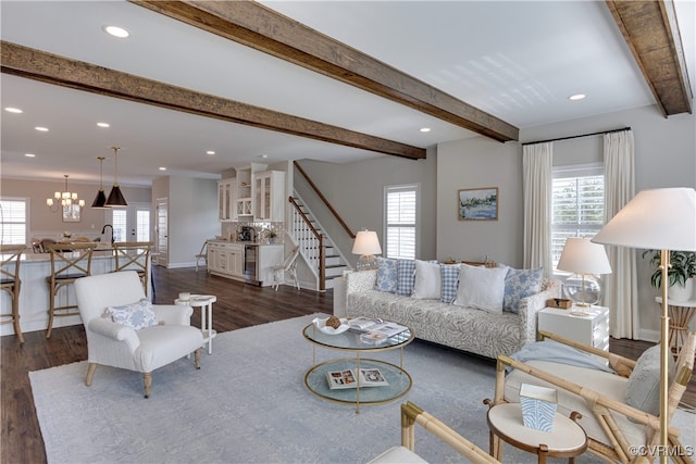 living area featuring stairway, a wealth of natural light, and beamed ceiling