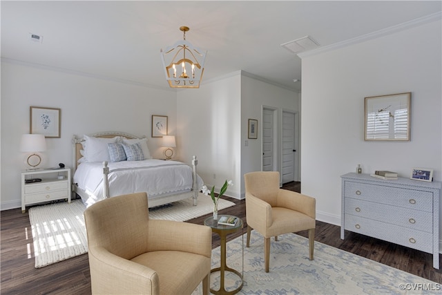 bedroom with baseboards, crown molding, visible vents, and wood finished floors