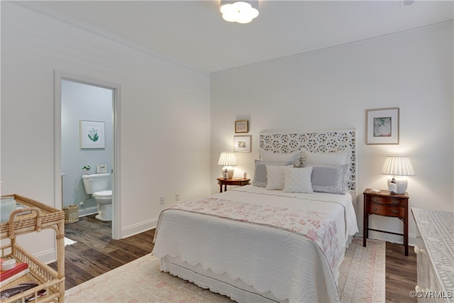 bedroom featuring baseboards, ensuite bathroom, wood finished floors, and ornamental molding