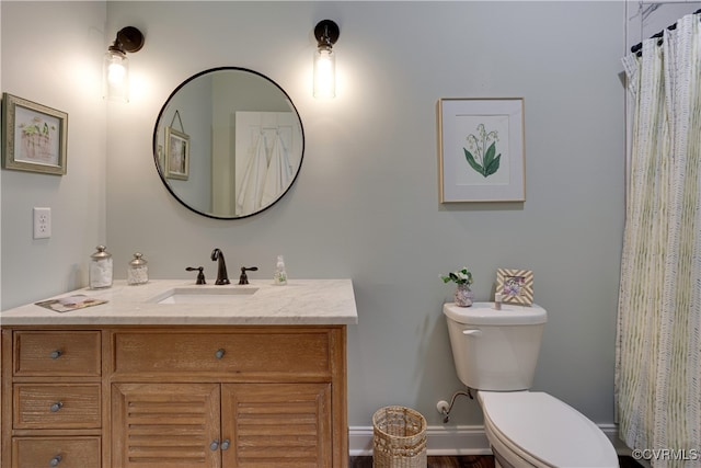 bathroom featuring vanity and toilet