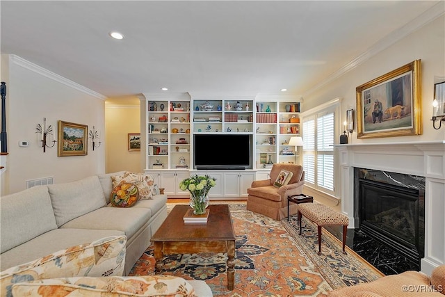 living area featuring ornamental molding, a high end fireplace, visible vents, and recessed lighting