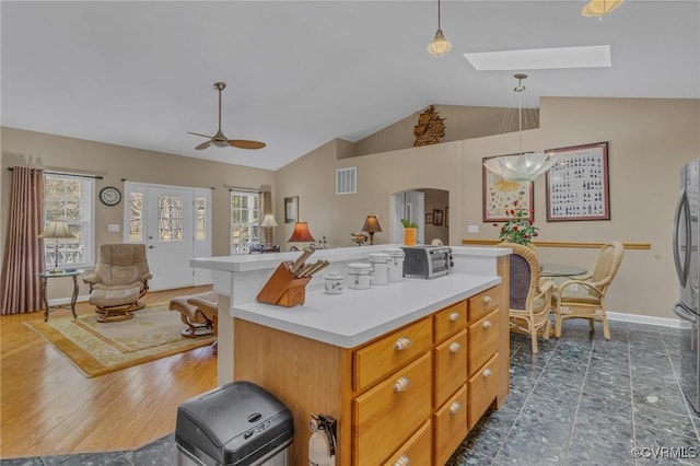 kitchen with a wealth of natural light, light countertops, open floor plan, and visible vents