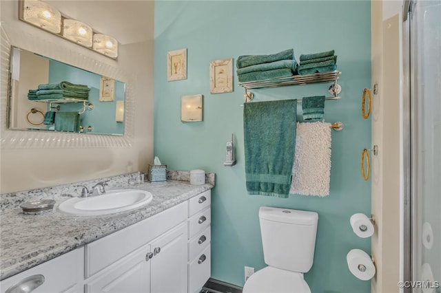 bathroom with toilet and vanity