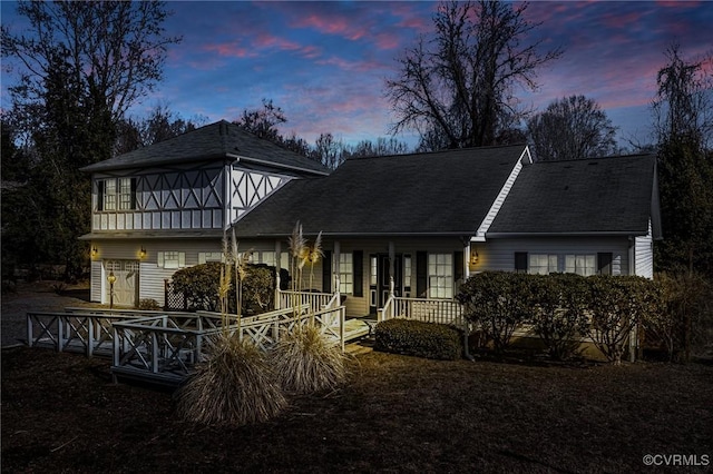 view of front facade featuring a porch and a shingled roof