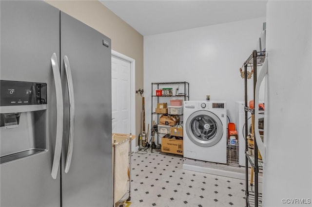 laundry area with laundry area, washer and clothes dryer, and light floors