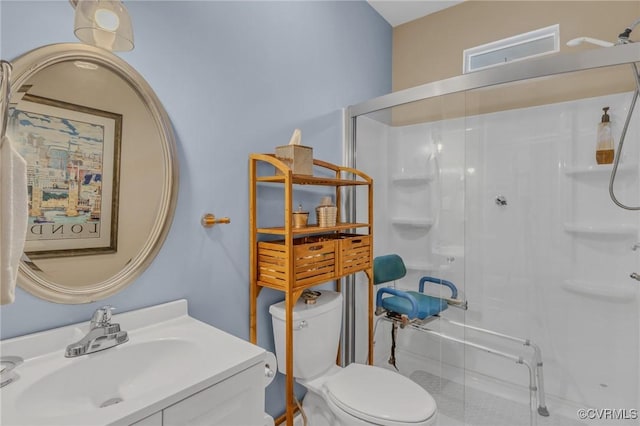 full bath with a stall shower, vanity, and toilet