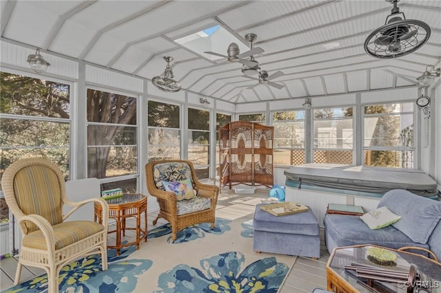 sunroom featuring lofted ceiling, a healthy amount of sunlight, and a ceiling fan