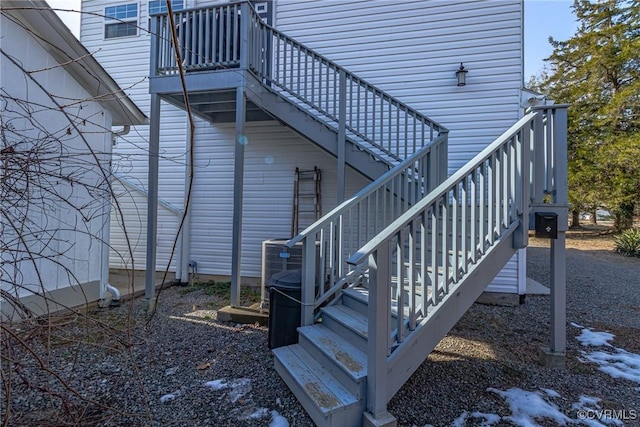 view of home's exterior with central air condition unit and stairs