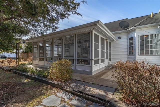 view of side of property featuring a sunroom