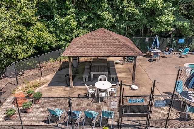 exterior space featuring a gazebo, fence, and a gate