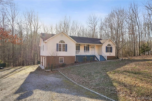 view of front of house with a porch, brick siding, ceiling fan, and driveway