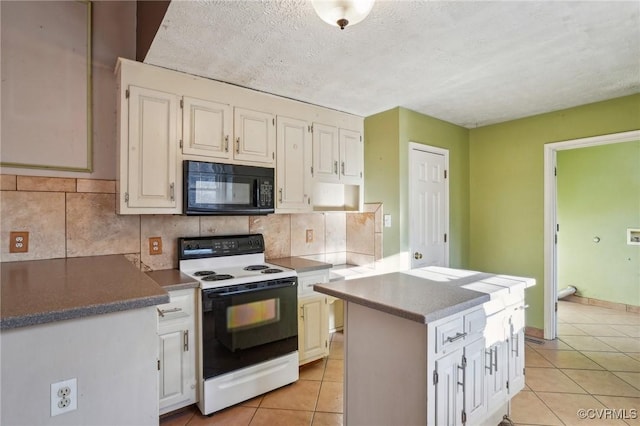 kitchen featuring electric stove, tasteful backsplash, light tile patterned flooring, white cabinetry, and black microwave