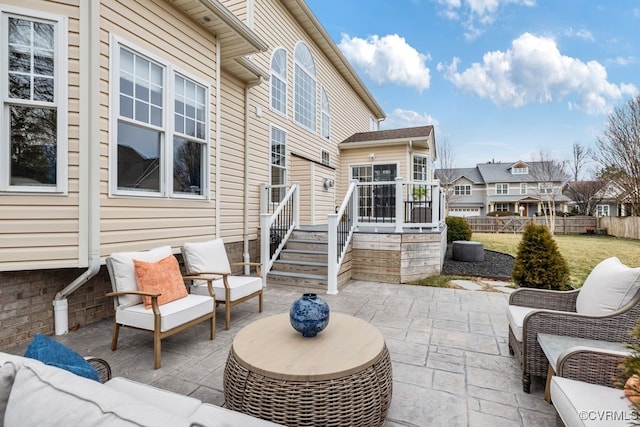 view of patio / terrace with a residential view, outdoor lounge area, and fence