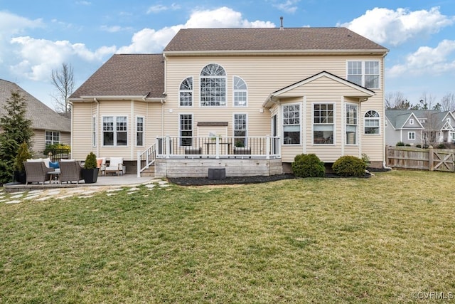 back of property featuring central AC unit, fence, a lawn, a wooden deck, and a patio area